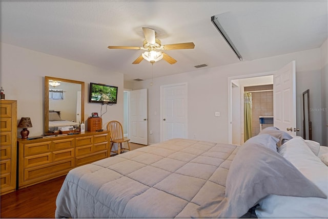 bedroom with dark wood finished floors, visible vents, and a ceiling fan