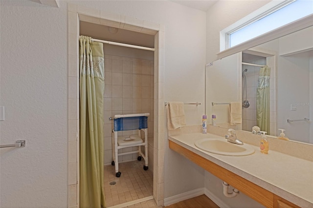 bathroom featuring a sink and a tile shower