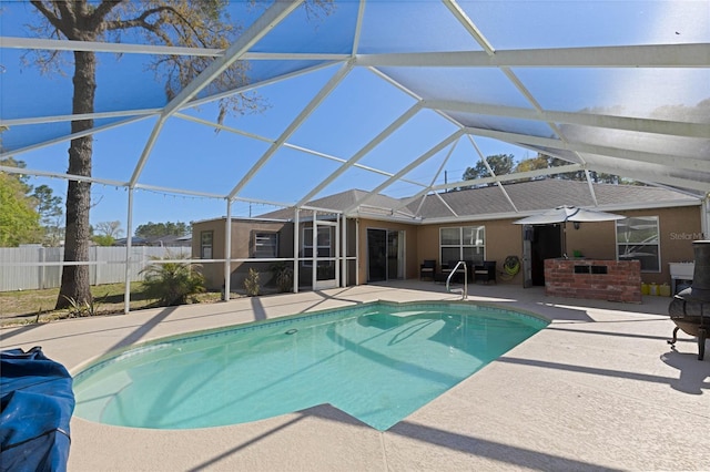 view of pool with a patio, fence, a fenced in pool, and a lanai