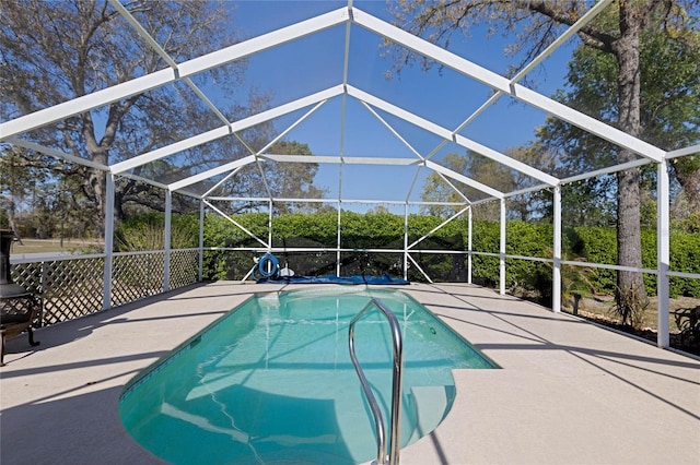 pool with glass enclosure and a patio