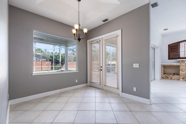 spare room with light tile patterned floors, baseboards, and visible vents