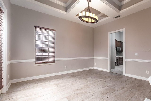 unfurnished room featuring visible vents, coffered ceiling, a notable chandelier, and wood finished floors