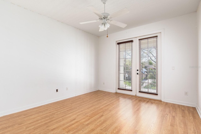 unfurnished room with light wood-style floors, ceiling fan, baseboards, and french doors