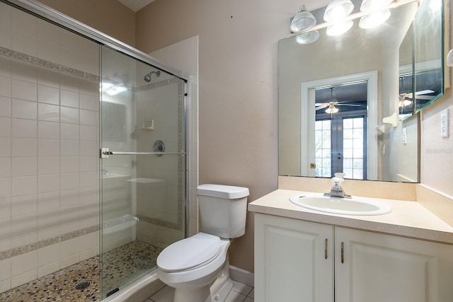 full bathroom featuring toilet, a stall shower, and vanity