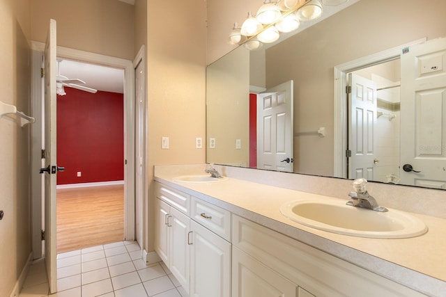 bathroom featuring a ceiling fan, tile patterned flooring, a sink, and double vanity