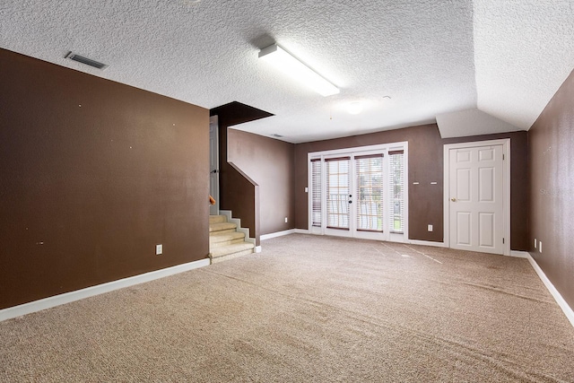 unfurnished living room featuring stairway, carpet flooring, visible vents, and baseboards