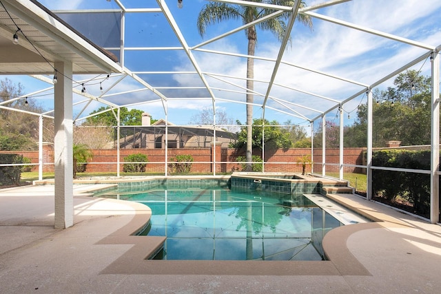 view of swimming pool featuring a lanai, a patio area, and a fenced backyard