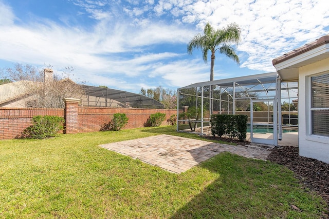 view of yard featuring a patio area, fence, and a lanai