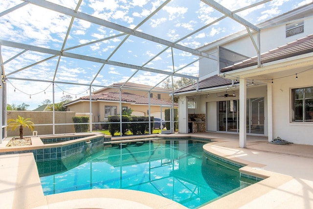 view of pool with a lanai, an in ground hot tub, a fenced in pool, and a patio