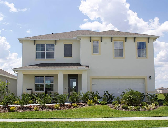 view of front of property featuring a porch, an attached garage, a front lawn, and stucco siding