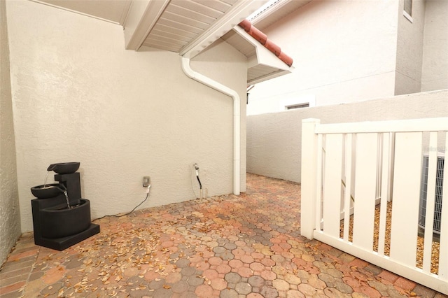 view of property exterior with fence and stucco siding