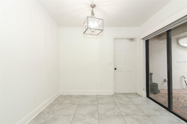 unfurnished dining area featuring light tile patterned floors and baseboards