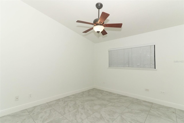 empty room with ceiling fan and baseboards