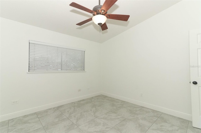 unfurnished room with a ceiling fan and baseboards