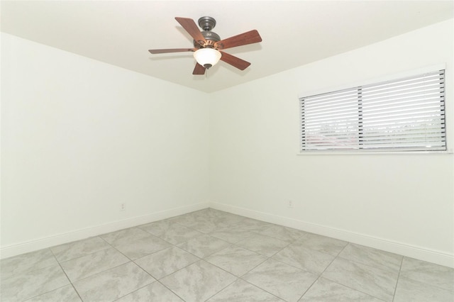 empty room with baseboards and a ceiling fan