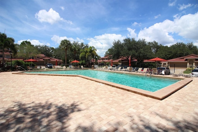 pool featuring a patio and fence