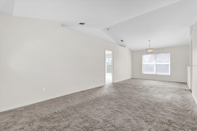 carpeted spare room featuring baseboards, lofted ceiling, a notable chandelier, and visible vents