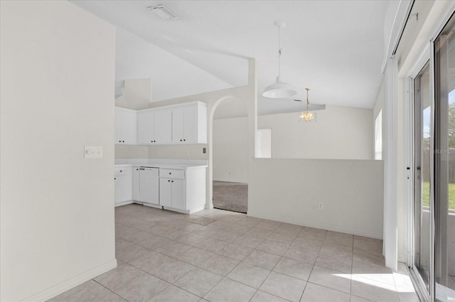 kitchen with a wealth of natural light, visible vents, lofted ceiling, and white dishwasher