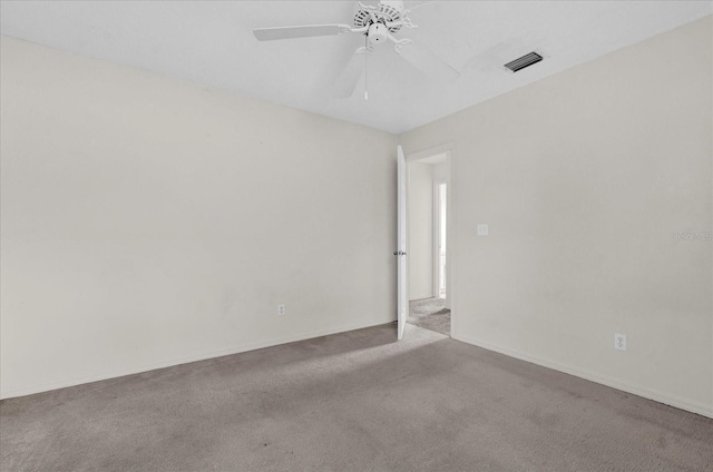 unfurnished room with visible vents, baseboards, ceiling fan, and carpet flooring