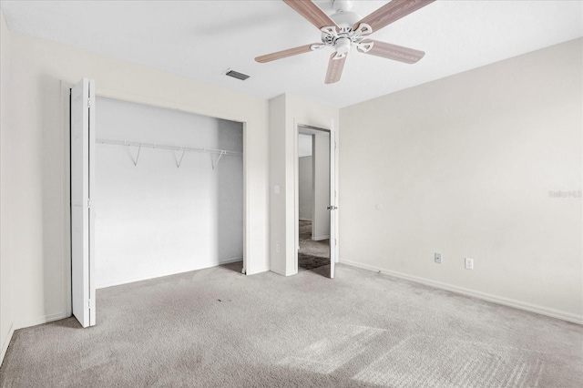 unfurnished bedroom with visible vents, a closet, carpet flooring, baseboards, and ceiling fan