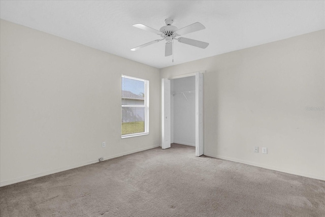 unfurnished bedroom with a closet, carpet flooring, baseboards, and a ceiling fan