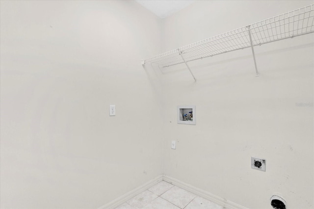 laundry room featuring baseboards, hookup for an electric dryer, laundry area, light tile patterned flooring, and washer hookup