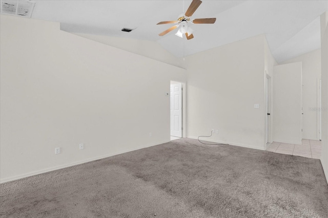 spare room with visible vents, light colored carpet, ceiling fan, and vaulted ceiling