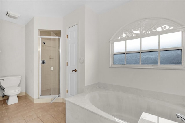 full bathroom featuring a garden tub, toilet, a shower stall, and tile patterned flooring