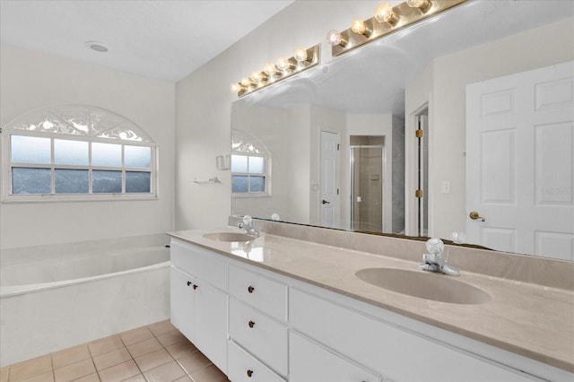 full bath featuring tile patterned floors, a shower stall, a bath, and a sink