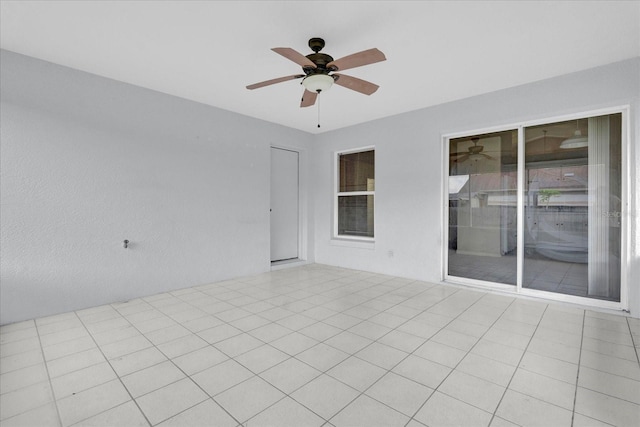 unfurnished room featuring light tile patterned floors and ceiling fan