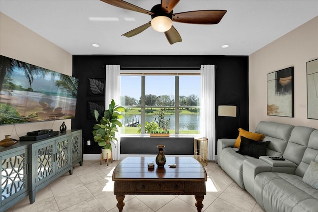 living room featuring ceiling fan, baseboards, and light tile patterned floors