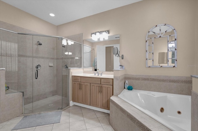 bathroom with a stall shower, tile patterned flooring, a tub with jets, and vanity