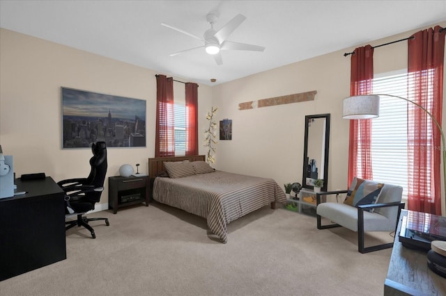 bedroom featuring a ceiling fan and light colored carpet