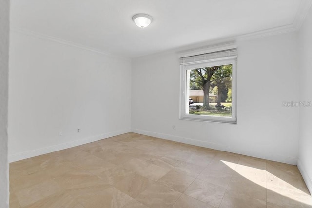 spare room featuring ornamental molding and baseboards