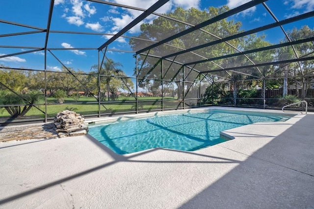 outdoor pool with a patio and glass enclosure