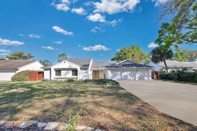 single story home featuring stucco siding, concrete driveway, an attached garage, fence, and a front lawn