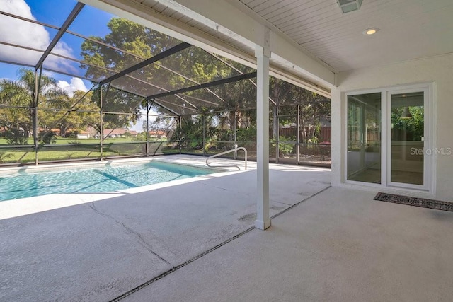 outdoor pool with a patio area and glass enclosure