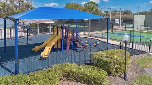 community jungle gym featuring community basketball court and fence