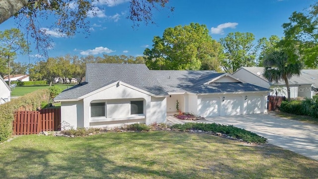 ranch-style home featuring stucco siding, fence, concrete driveway, a front yard, and an attached garage