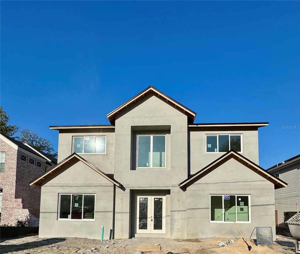 back of house with french doors and stucco siding