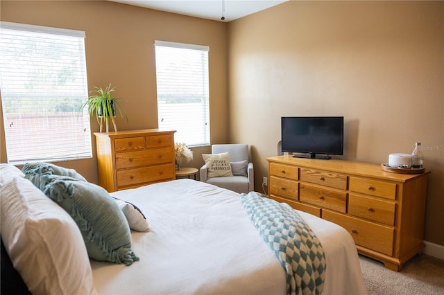 bedroom featuring light carpet