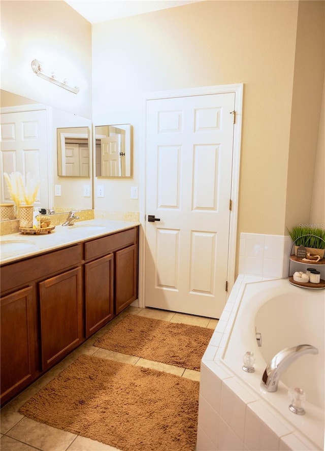 full bathroom featuring tile patterned flooring, double vanity, a bath, and a sink