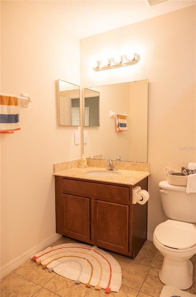 bathroom with visible vents, toilet, tile patterned flooring, baseboards, and vanity