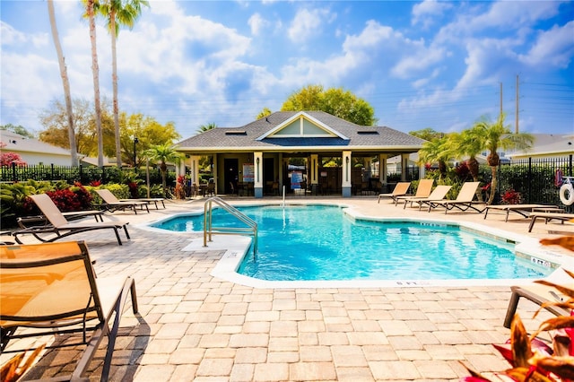 pool featuring a patio and fence