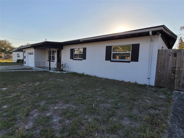 1616 Ferndell Rd, Orlando, FL 32808 - single story home featuring a front yard, an attached garage, and brick siding