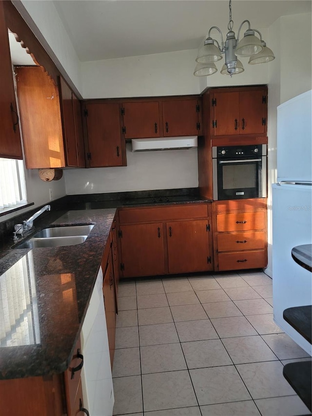 1616 Ferndell Rd, Orlando, FL 32808 - kitchen with light tile patterned floors, exhaust hood, an inviting chandelier, a sink, and white appliances