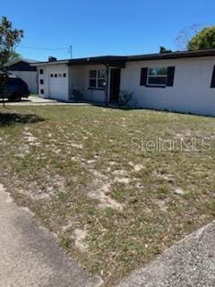 1616 Ferndell Rd, Orlando, FL 32808 - ranch-style house featuring a garage and a front lawn