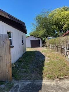 1616 Ferndell Rd, Orlando, FL 32808 - view of yard with an outbuilding, a shed, a garage, and concrete driveway