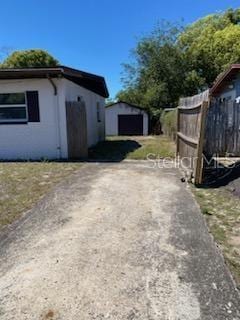 1616 Ferndell Rd, Orlando, FL 32808 - exterior space with an outdoor structure, driveway, and a storage unit