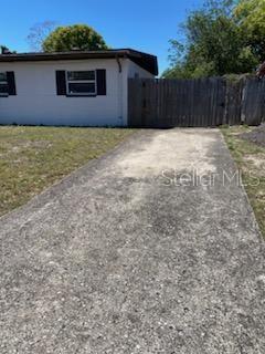 1616 Ferndell Rd, Orlando, FL 32808 - view of property exterior with driveway and fence